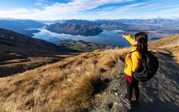 Young person hiking on Roys peak track, Wanaka, South Island, New Zealand