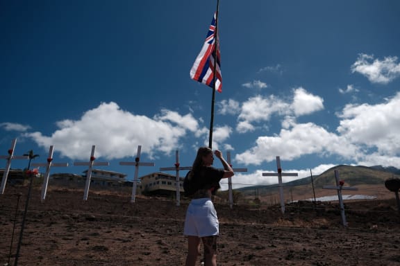 Lots of crosses are attached by local residents to mourn the victims on a hill overlooking Lahaina, the western part of the Maui island, which has been devastated by wildfire, in Maui, Hawaii, United States on August 22, 2023.( The Yomiuri Shimbun ) (Photo by Hiroto Sekiguchi / Yomiuri / The Yomiuri Shimbun via AFP)
