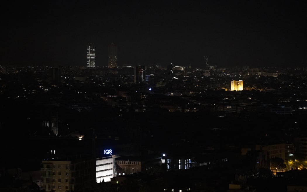 This photograph shows a general view of Barcelona at night, partially without electricity, following a massive power cut affecting the entire Iberian peninsula and the south of France, on April 28, 2025. A "massive" power cut late on April 28, 2025 morning affected the whole of the Iberian peninsula and part of France, according to Portuguese electricity network operator REN. (Photo by Josep LAGO / AFP)