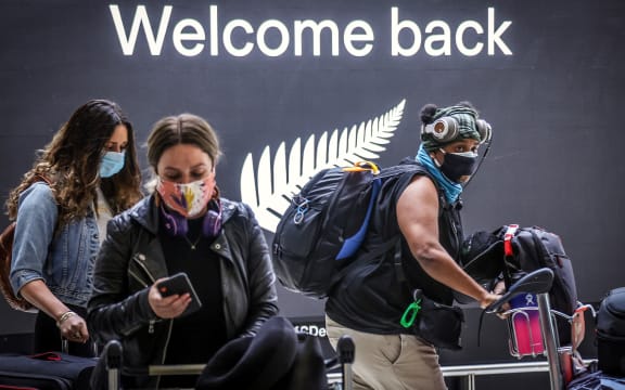 Passengers wearing masks arrive from New Zealand at Sydney International Airport on October 16, 2020.