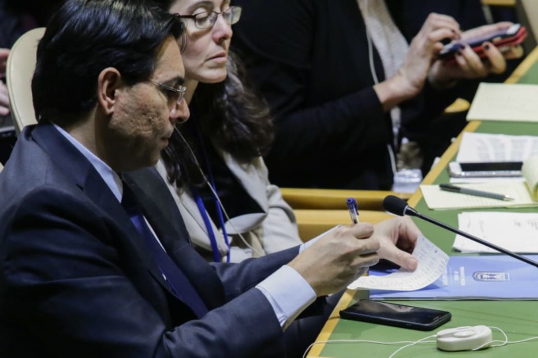Israel representative to the United Nations, Danny Danon, checks his list of voters at UN Headquarters in New York.