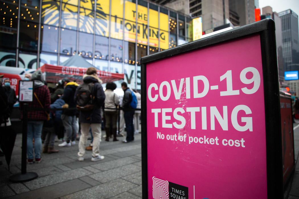 Crowds line up in Times Square on 18 December 2021 to get tested for Covid-19 as cases sharply rise in the city ahead of the holidays.