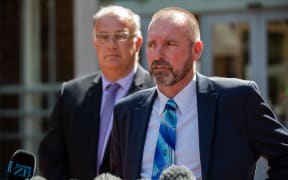 Detective Inspector Scott Beard, right, speaks to media outside the High Court at Auckland following the sentencing of Grace Millane's murderer, 21 February 2020.