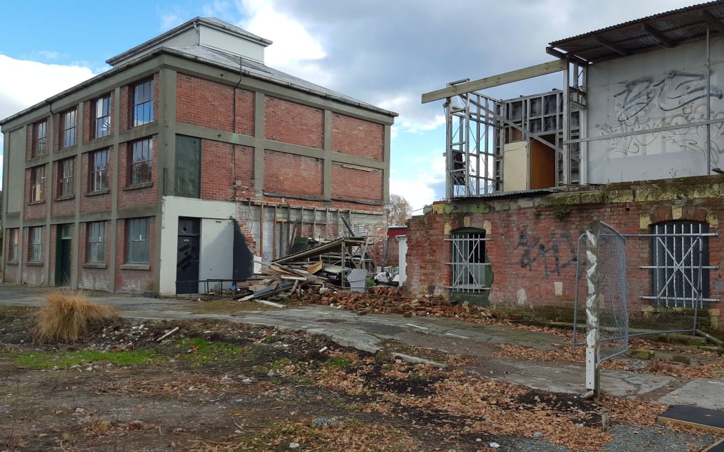 Two brick, two storey buildings. One severely damaged.