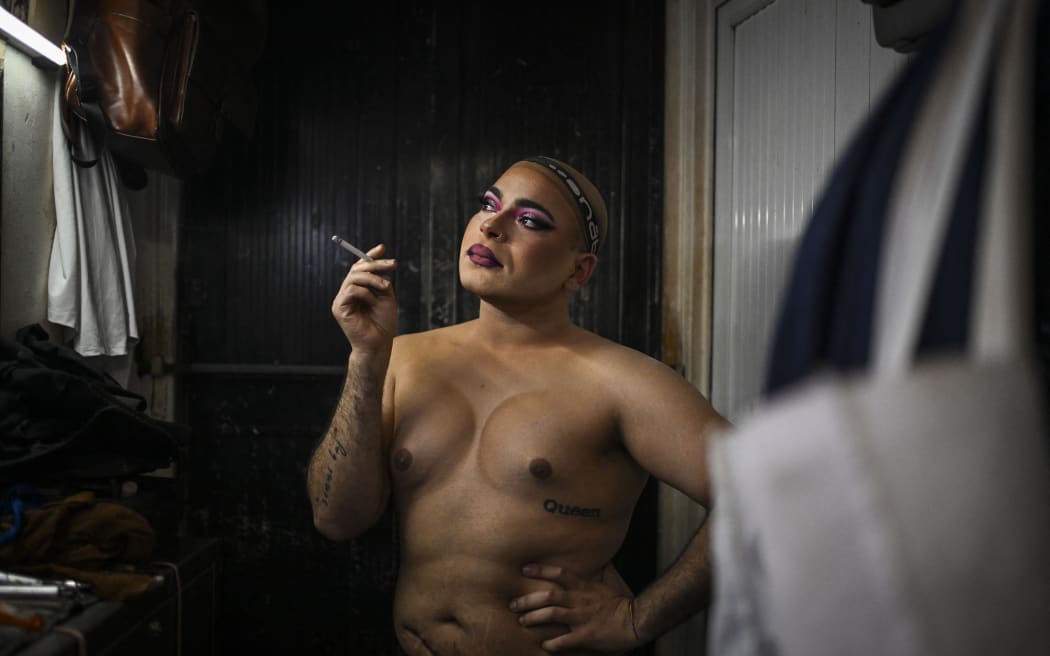 Drag queen Pariga smokes a cigarette in the backstage before a drag queens show at Finalmente Club in Lisbon on May 26, 2025.. Finalmente Club, opened in 1976, is one of the most iconic gay clubs in Portugal.