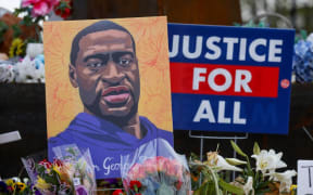 MINNEAPOLIS, MINNESOTA - APRIL 21: People lay flowers at a memorial in George Floyd Square in Minneapolis, Minnesota, United States on April 21, 2021.