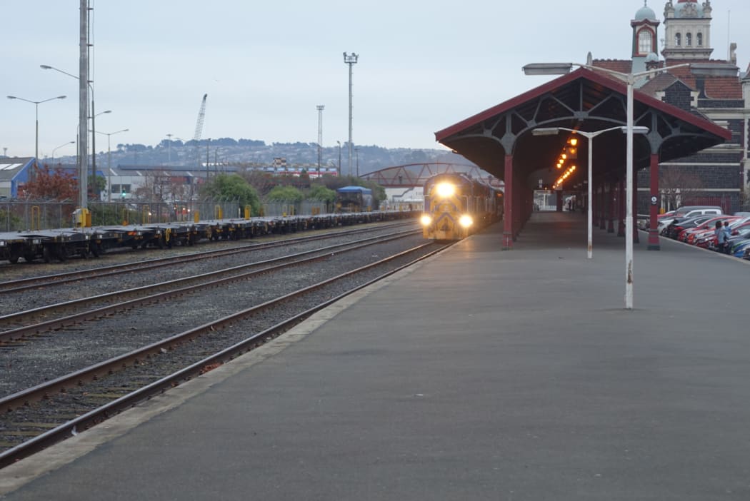 A locomotive and carriages used on Dunedin's Taieri Gorge Railway leaving the city