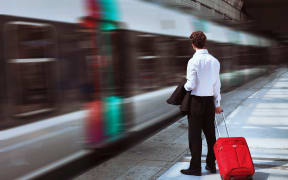 Businessman at train station.