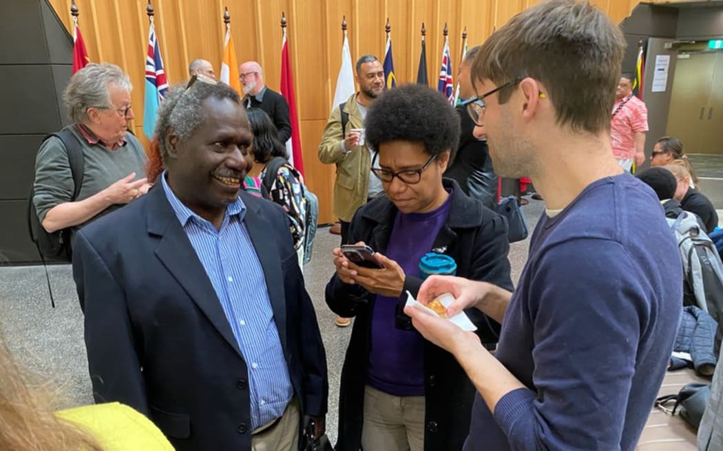 Former Bougainville president and External Relations Directorate international legate James Tanis speaks with delegates at ANU State of the Pacific conference in Canberra, pictured on Sept 5, 2024. [