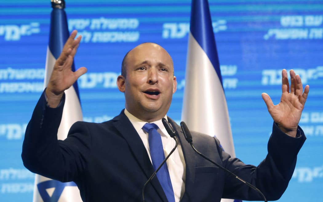 Naftali Bennett, leader of the Israeli right-wing Yamina ('New Right') party, addresses supporters at his party's campaign headquarters in the Mediterranean coastal city of Tel Aviv early on March 24, 2021,