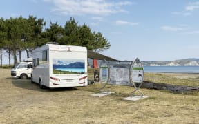Holidaymakers camp out at the beach front.