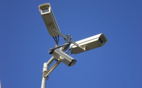 Three video surveillance cameras on a stand