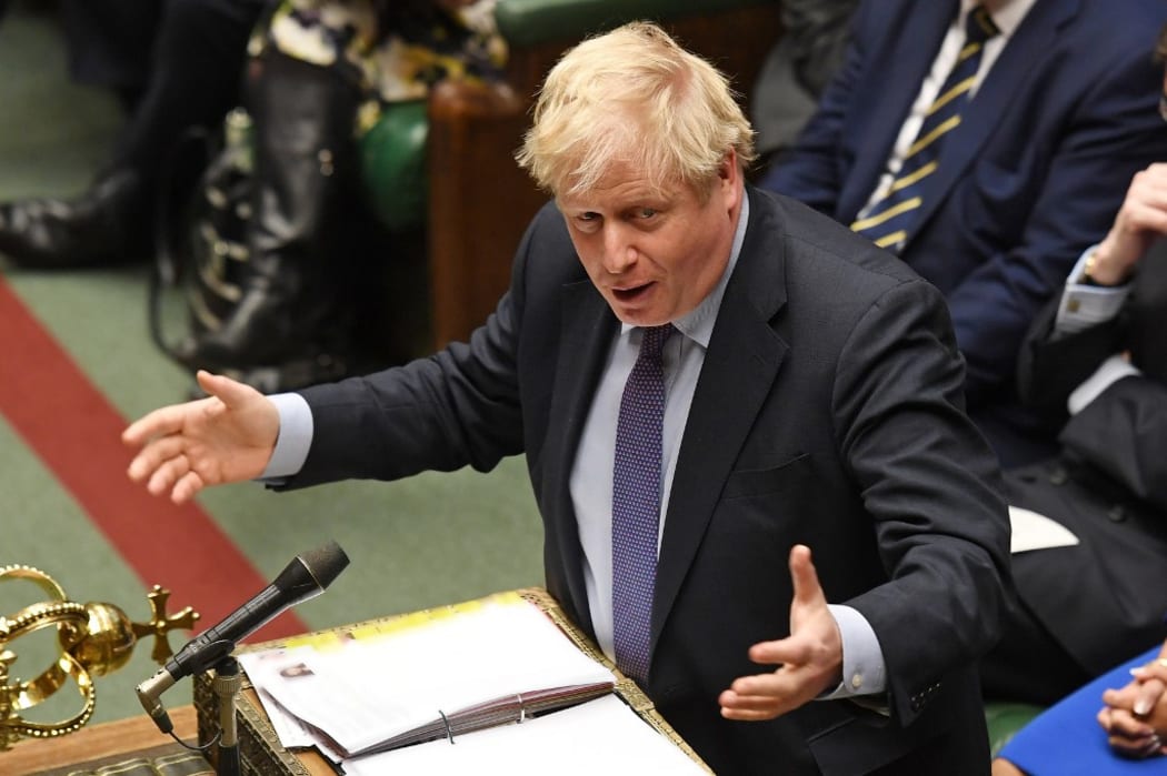A handout photograph released by the UK Parliament shows Britain's Prime Minister Boris Johnson speaking in the House of Commons in central London.
