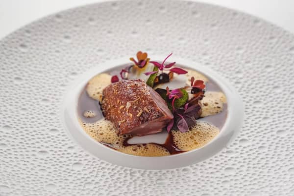 Roasted Qingyuan pigeon, caramel-brined overnight and dry-aged for 8 days.