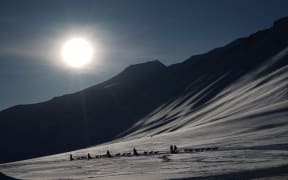 Tourists ride dog sleds outside of Longyearbyen, Svalbard, ahead of the 20 March total solar eclipse.
