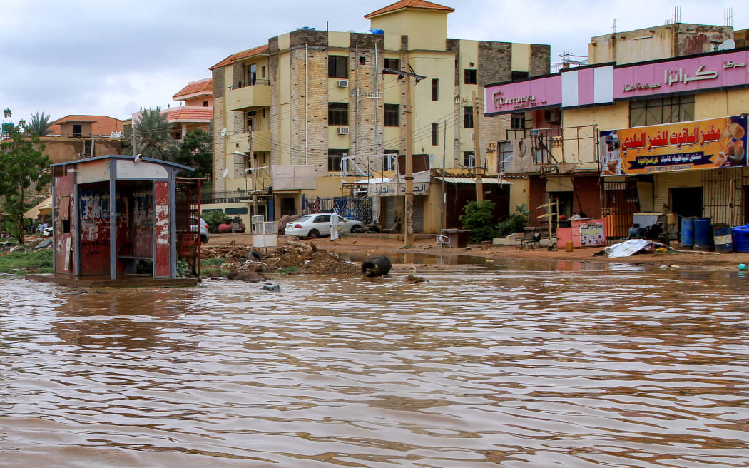Flood water inundates a main street in Sudan's capital Khartoum following heavy rain on August 27, 2025. (Photo by Ebrahim Hamid / AFP)