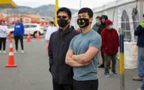 People wearing masks line up at Christchurch's mobile testing station for Covid-19 coronavirus at Pak n Save on Moorhouse Ave.
