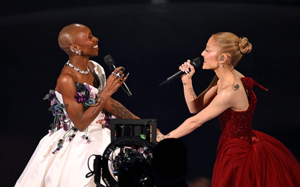 British singer and actress Cynthia Erivo (L) and US singer and actress Ariana Grande perform onstage during the 97th Annual Academy Awards at the Dolby Theatre in Hollywood, California on March 2, 2025. (Photo by Patrick T. Fallon / AFP)