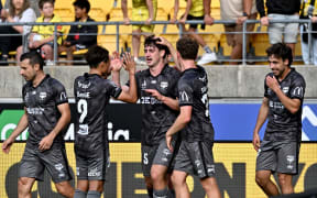 Isaac Hughes, second from right, celebrates after scoring a goal for the Wellington Phoenix against Brisbane Roar during the A-League men's match at Sky Stadium, Wellington, 6 Feb, 2025.