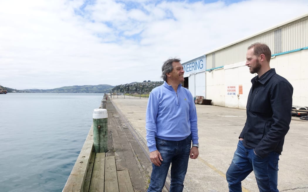 The pair discuss the plans at Dunedin’s waterfront. Pictured at the rear is the site of a proposed hotel and cultural centre.
