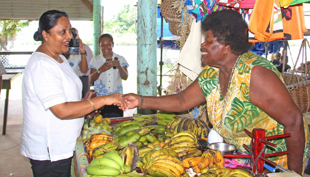 Fiji's Minister for Local Government Premila Kumar with a vendor at the Savusavu Market.