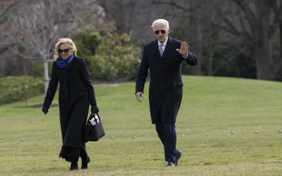 US President Joe Biden and First Lady Jill Biden walk on the South Lawn of the White House as they return to Washington, DC, from Camp David, on January 2, 2025. (Photo by Chris Kleponis / AFP)