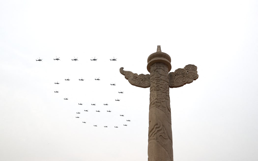 Helicopters fly over Tian'anmen Square in the formation of "100" ahead of a grand gathering celebrating the Communist Party of China centenary at Tian'anmen Square in Beijing, 1 July, 2021.