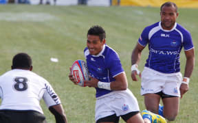 Anthony Tailua of Samoa looks to avoid Josua Tuisova of Fiji at the 2013 Las Vegas Sevens.