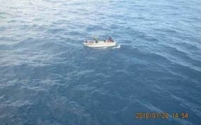 The ferry's boat with the seven survivors approaching the fishing vessel.