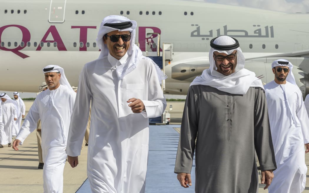 Emirati President Sheikh Mohamed bin Zayed Al-Nahyan (right) welcoming Qatar's Emir, Sheikh Tamim bin Hamad al-Thani, at the presidential airport in the capital Abu Dhabi on 18 January, 2023.