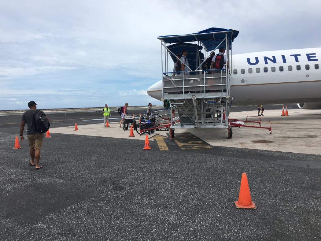 People boarding a flight in Majuro bound for Guam