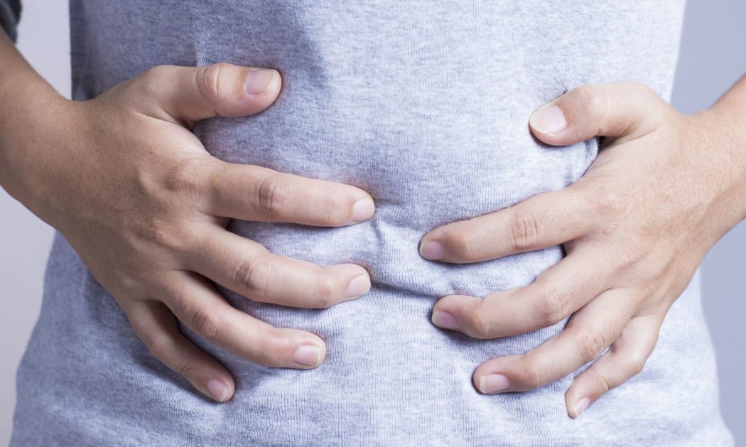 woman clutching stomach