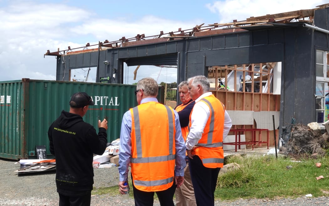 Juicy Media owner James Taylor shows Northland MP Grant McCallum, Kaipara Mayor Craig Jepson and Emergency Management Minister Mark Mitchell what’s left of his business.