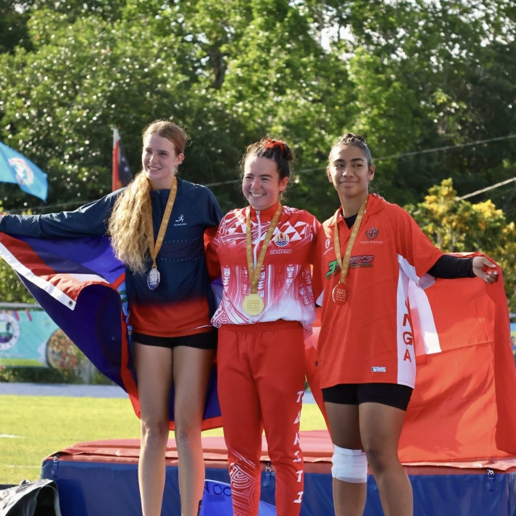 Tonga's Manatu Hafoka (right) with her bronze medal in the women's 110m hurdle, along with Tahiti's Kiara Gilroy who won gold and silver medalist Hazel Wilson of Guam.