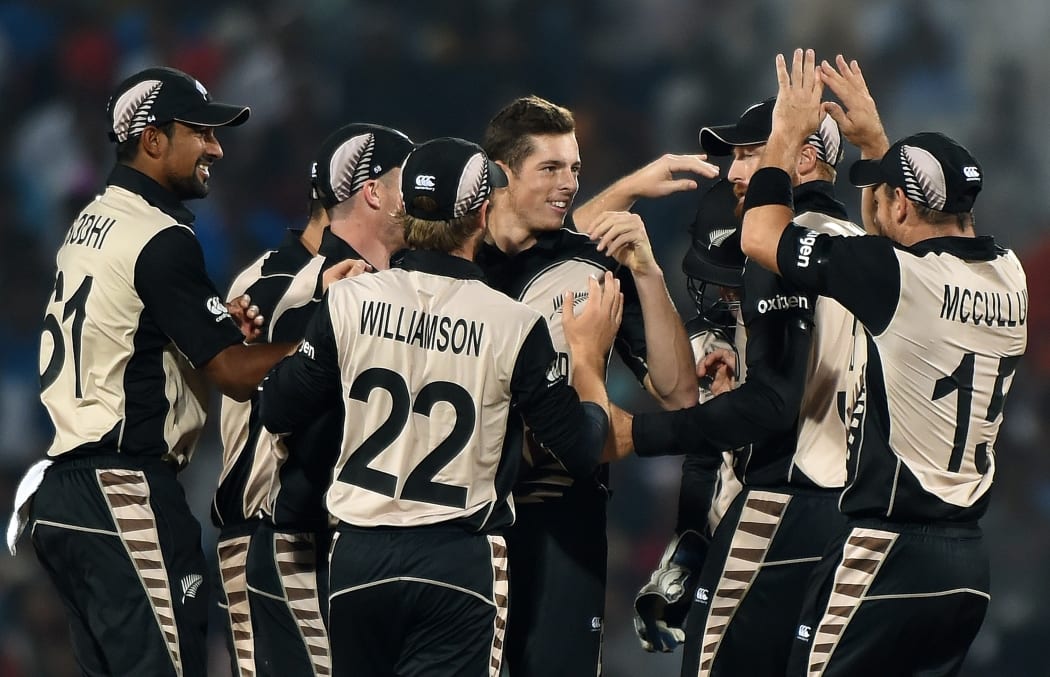 New Zealand bowler Mitchell Santner, centre, celebrates the wicket of India's Rohit Sharma during the World T20 match in Nagpur on 15 March 2016.