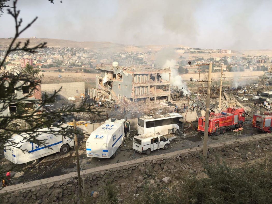 Turkish police and firefighters parked near the damaged police headquarters in Cizre.