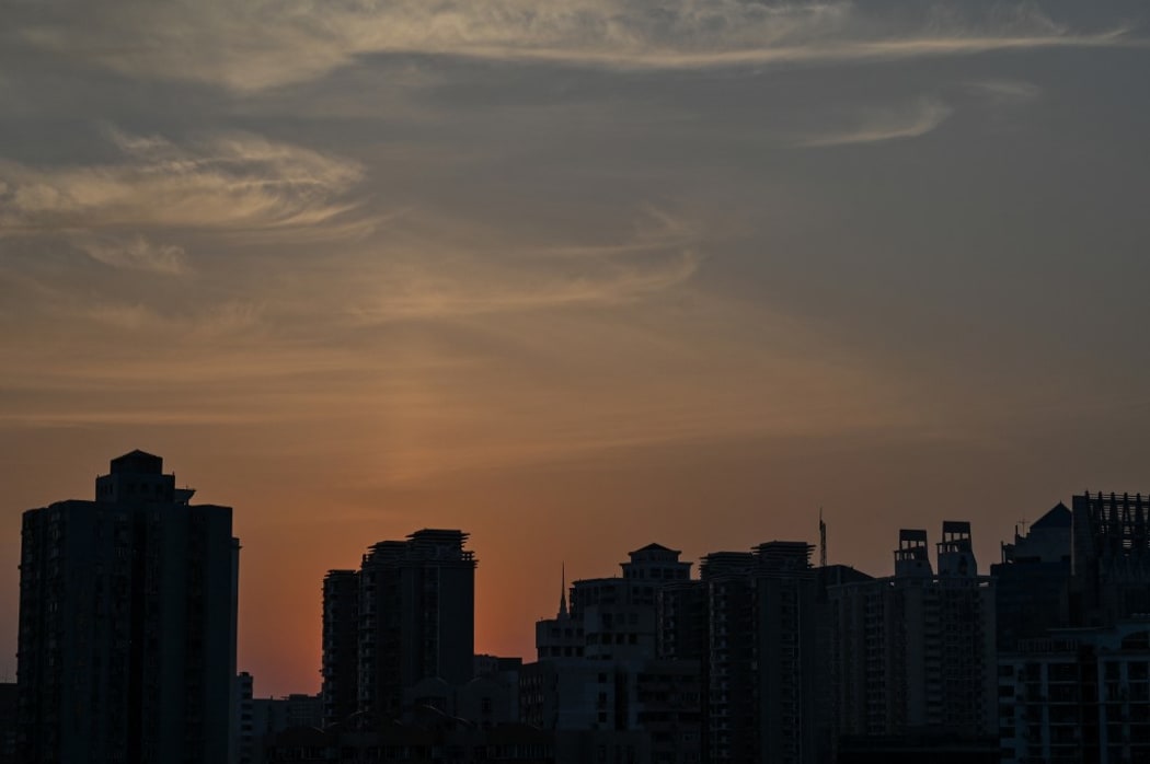 View of residential units during a Covid-19 coronavirus lockdown in the Jing'an district of Shanghai on May 2, 2022. (Photo by Hector RETAMAL / AFP)