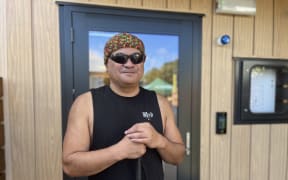 Ivan Te Momo stands in front of his new Kāinga Ora house, after two years spent in Emergency Housing