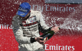 New Zealand driver Earl Bamber celebrates winning 2014 Porsche Super Cup title.