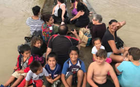 Edgecumbe residents evacuate the town on board a flatdeck truck