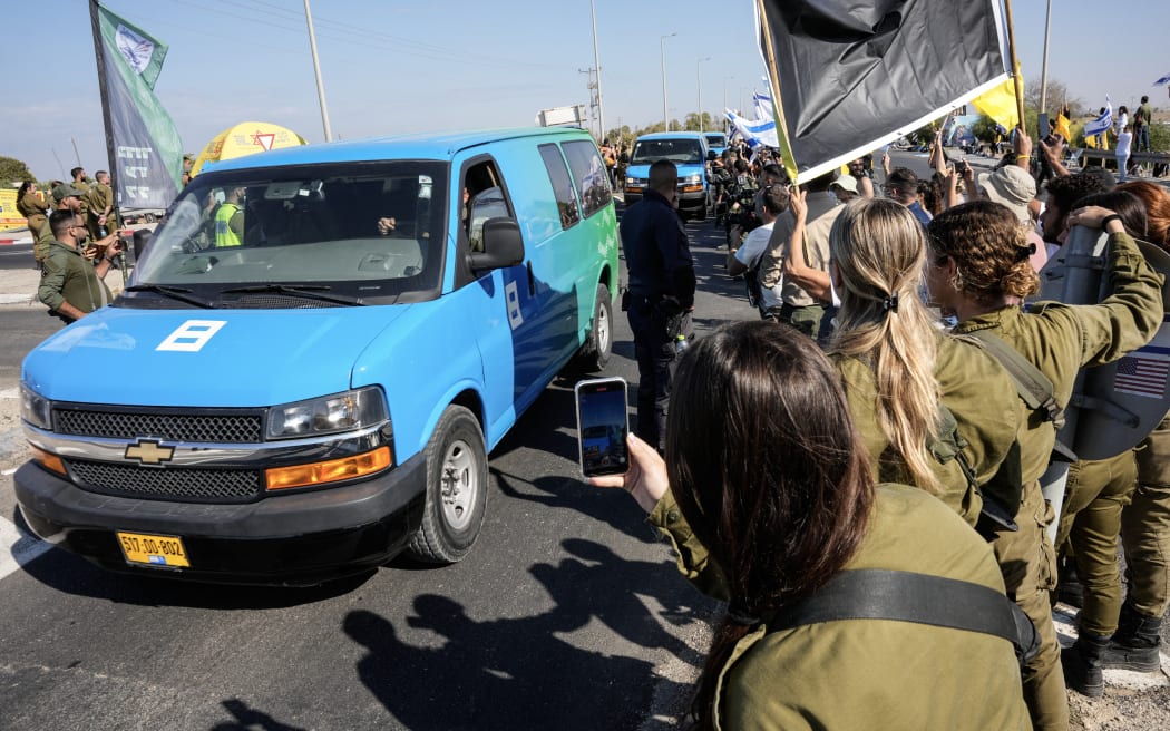 Vehicles carrying hostages who were released by Hamas from the Gaza Strip arrive to the Reim military base near the border with Gaza in southern Israel.