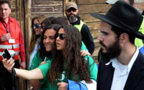 Girls take a selfie at the March of the former Nazi death camp Aushwitz