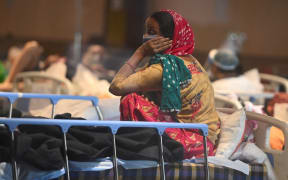 A patient rests inside a banquet hall temporarily converted into a Covid-19 ward in New Delhi on April 27, 2021.