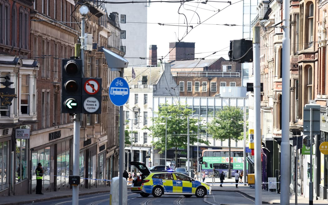 A police officer stands by a cordon outside on Market Street in Nottingham, central England, during a 'major incident' in which three people have been found dead. UK police on Tuesday locked down the central English city of Nottingham after three people were found dead in a "horrific and tragic incident". A 31-year-old man had been arrested on suspicion of murder, police said, adding that they were also investigating another incident which they believed was linked, in which a van had attempted to run over three people. (Photo by Darren Staples / AFP)