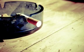 cigarette butt in ash tray