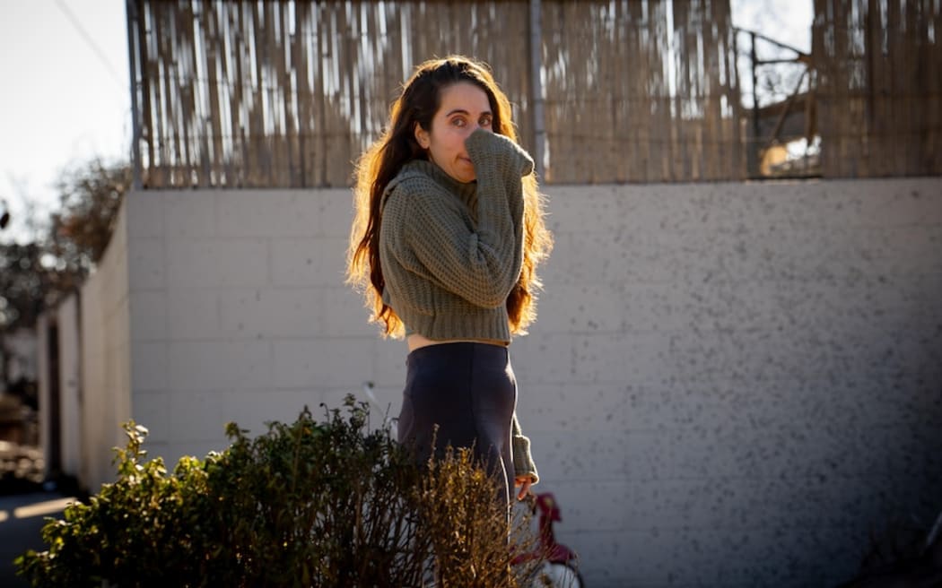 Maria House surveys what is left of her burned-out home.