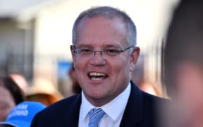 Australia's Prime Minister Scott Morrison talks to the media outside a polling booth during Australia's general election in Sydney on May 18, 2019.