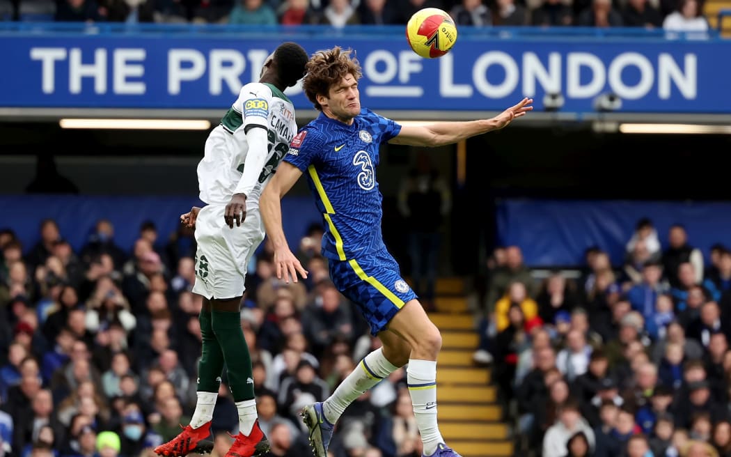 Marcos Alonso of Chelsea competes for a header with Panutche Camara of Plymouth Argyle
