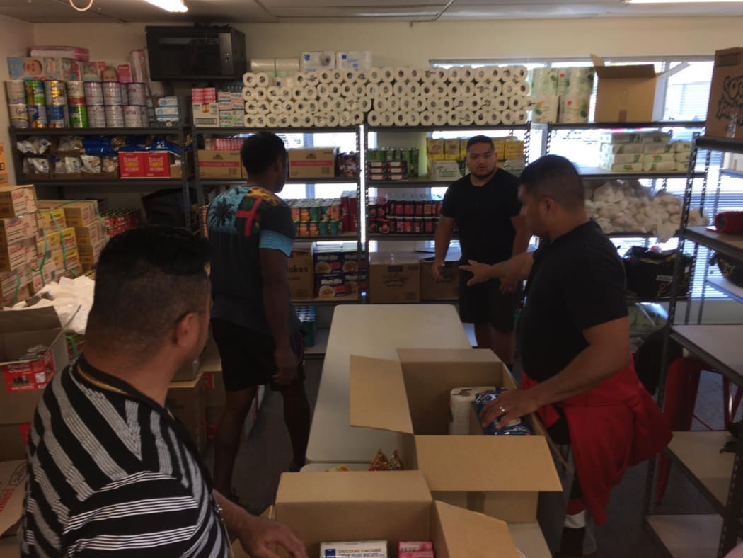 Volunteers organise food packs for families during the lockdown in Auckland.