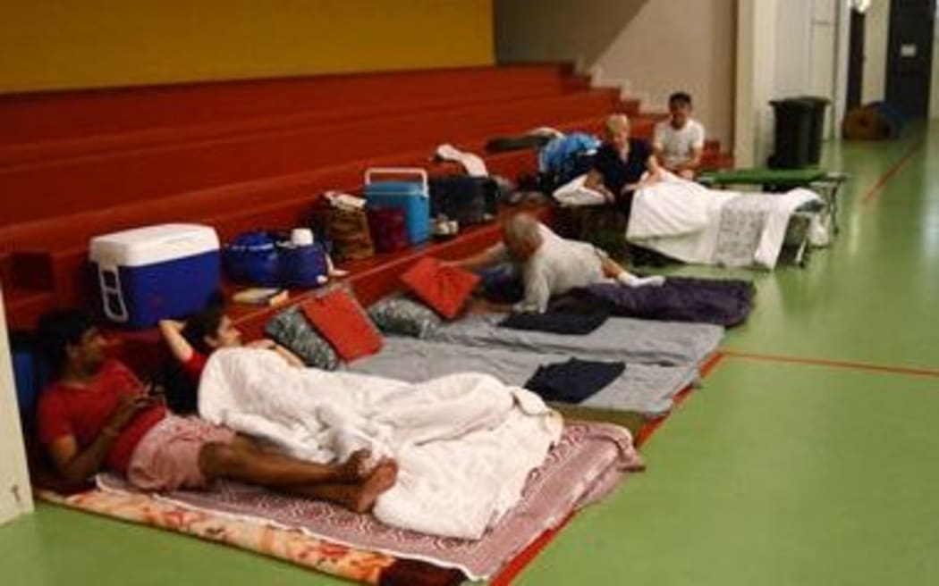 People prepare for Cyclone Ita a an evacuation centre in Cooktown.